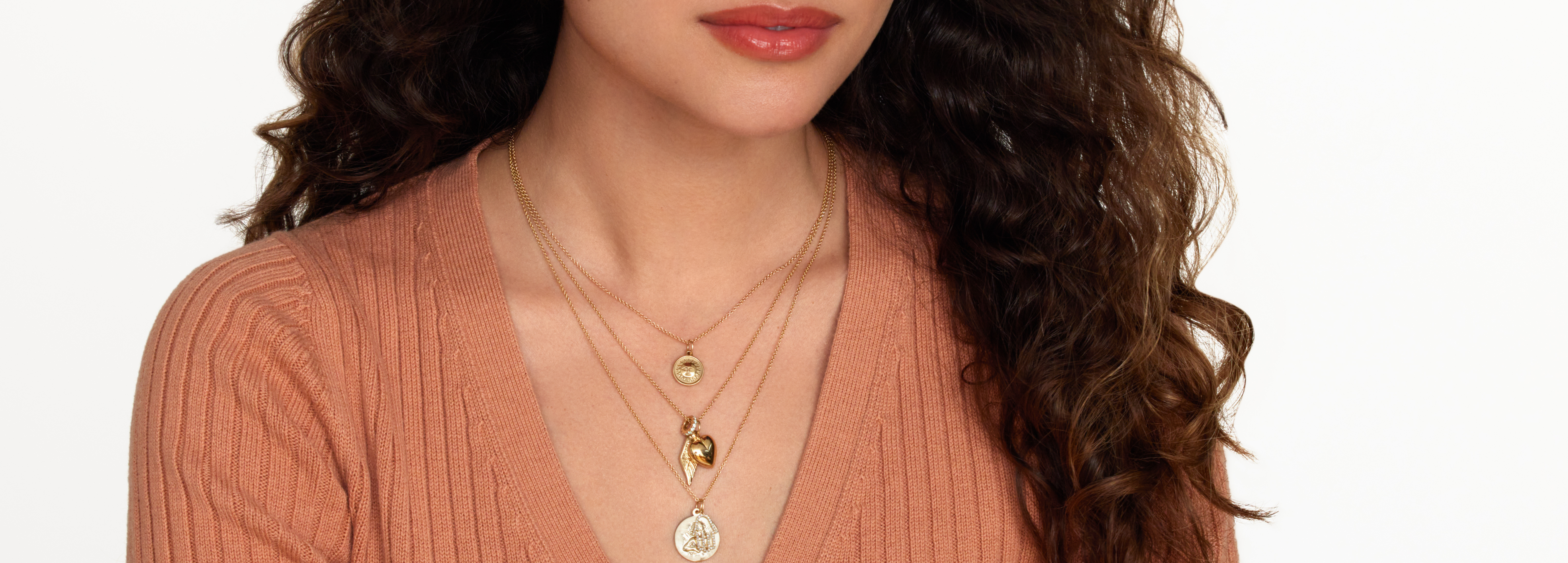 woman wearing 3 religious necklaces